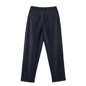 Detail of pinstripe trousers featuring back welt pockets and cuffed hems for women
