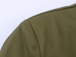 Detailed close-up showing olive green twill fabric and shoulder seam of the blazer jacket
