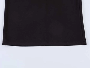Detailed close-up of the double-needle stitched hem on a black sleeveless dress