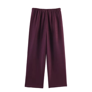 Detail of high-waist deep purple wide-leg trousers with an elastic waistband design
