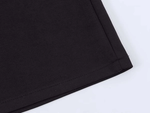 Close-up detail of double-stitched hem on a black sleeveless backless dress
