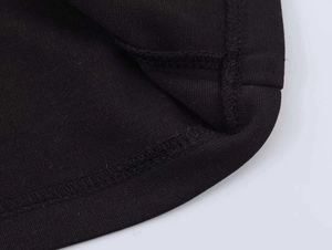 Detailed close-up showing high-density black knit fabric and precise double-needle stitching