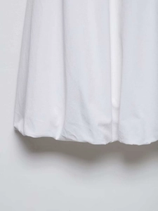 Detail of white midi skirt featuring a cotton twill fabric and rounded bubble hem design