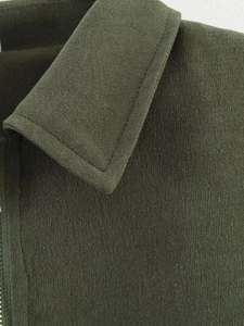 Detailed close-up of dark olive green bomber jacket collar with fine woven fabric texture