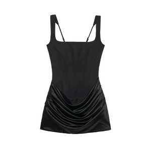 Détail de la robe corset noire avec jupe en satin plissée et structure baleinée