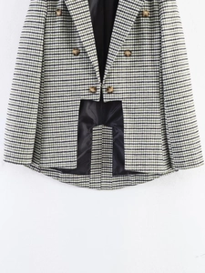 Detailed view of the double-breasted houndstooth blazer with vintage bronze buttons