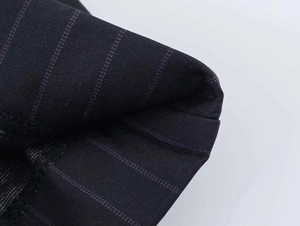 Detail shot of the black pinstripe fabric showing fine texture and quality tailoring