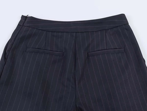 Detail of pinstripe trousers showing back welt pockets and hidden side zipper closure