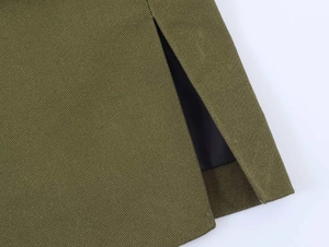 Close-up of olive green twill fabric blazer hem featuring a side slit and black lining