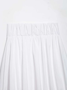 Detailed macro shot of white elastic pleated waistband on this summer midi skirt