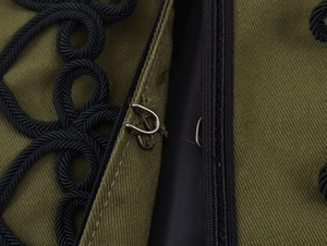Close-up of olive blazer with black woven rope knot and metal hook closure detail