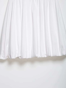 Detailed macro view of white pleated balloon midi skirt hem with fine vertical accordion folds