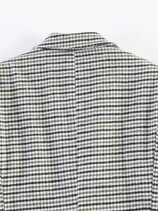 Detail of the green houndstooth blazer showing high-quality stitching on the back collar