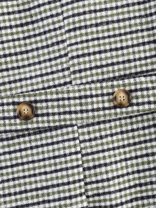 Detail shot of green checkered wool fabric with brown marble texture resin buttons