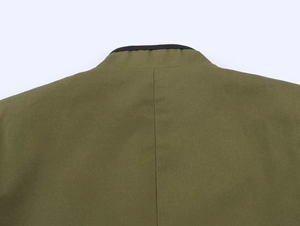 Detail of olive green blazer neckline with black piping and textured twill fabric