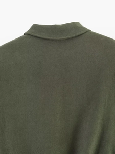 Detailed view of olive green bomber jacket collar with premium cotton texture and fine stitching