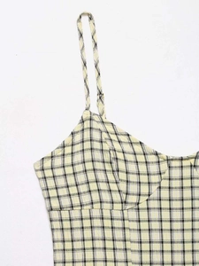Detail of summer yellow plaid midi dress with slim spaghetti straps and structured bodice