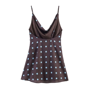 Detailed view of dark brown polka dot mini dress with silk finish and thin straps