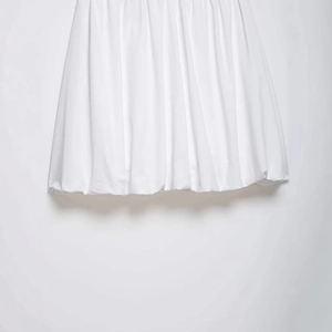 Minimalist white midi balloon skirt with fine vertical pleats and smooth hemline detail
