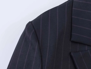 Detail shot of navy blue pinstripe blazer fabric showing high-quality twill weaving texture