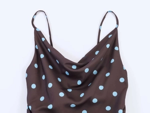 Detail of cowl neck on deep brown satin dress with light blue polka dot pattern