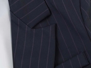 Close-up of navy blue pinstripe blazer featuring notched lapels and fine wool texture