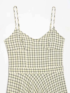 Detail of the structural bust stitching and plaid pattern on this vintage midi dress