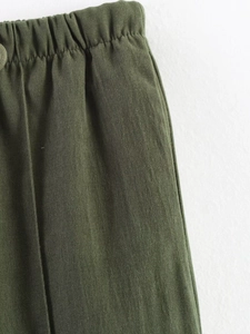 Detail of army green cotton-linen pants showing the elastic pleated waistband texture