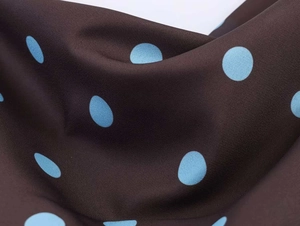 Detail of dark brown crepe fabric with light blue polka dots for summer strap dress