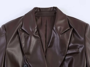 Detail of dark brown PU leather blazer featuring notch lapels and fine stitching