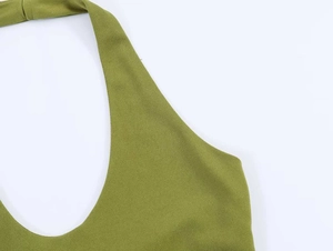 Detail view of olive green pleated fabric texture and stitching on summer dress