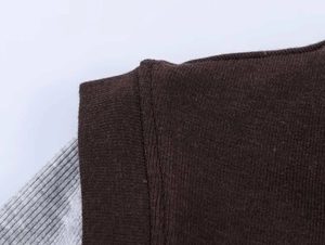 Detail of grey and dark brown color-block knit stitching on long sleeve T-shirt