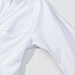 Detailed close-up showing the precise stitching and twill texture of the white jacket sleeve