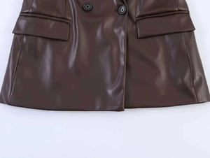 Close-up of the dark brown PU leather blazer featuring black buttons and flap pockets