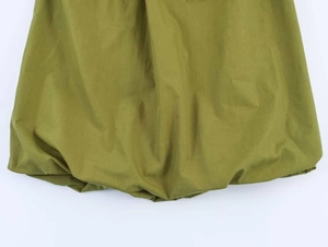 Detail of olive green pleated hem with bubble style and textured cotton-linen fabric