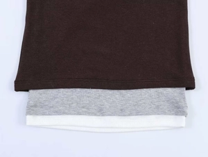Close-up of layered hem showing coffee, grey and white ribbed fabrics for the t-shirt