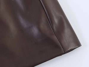 Close-up of dark brown PU leather jacket with detailed side stitching and premium texture