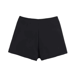 Detail view of high-waisted black asymmetric skort with clean lines and premium fabric