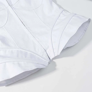 Detail of white structured corset jacket featuring twill texture and boning support