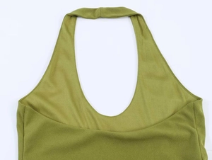 Detail of the halter neckline and olive green knit texture on a summer pleated dress