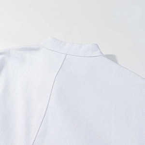 Detail of white slim-fit jacket showing stand collar and fine twill fabric texture