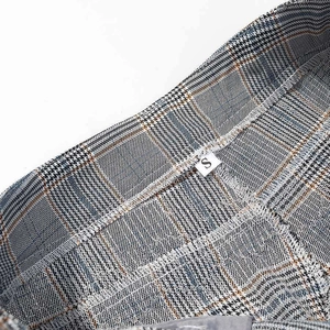 Detail of classic plaid pants waistband showing the size S label and premium fabric texture