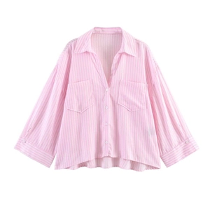 Detail of pink and white vertical striped long sleeve shirt with front pockets and curved hem