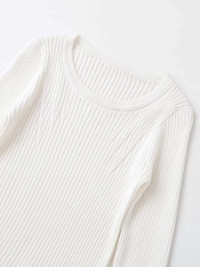 Detail of white ribbed knit sweater featuring a round neck and textured weave patterns