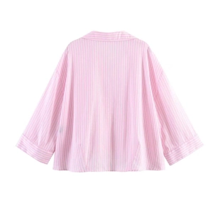 Back view of a pink and white striped short shirt with three-quarter sleeves and loose fit