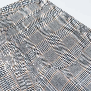 Close-up of Prince of Wales check fabric with subtle sequins on commute suit trousers