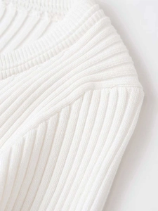 Detail of premium white ribbed knit fabric showing fine stitching and soft texture