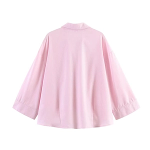Detail view of pink loose-fit shirt with drop shoulders and soft cotton fabric