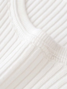 Detailed macro view of white ribbed knit fabric texture and crew neck stitching finish