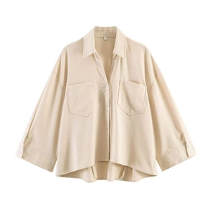Detail of light beige button-down shirt with V-neckline and dual chest pockets